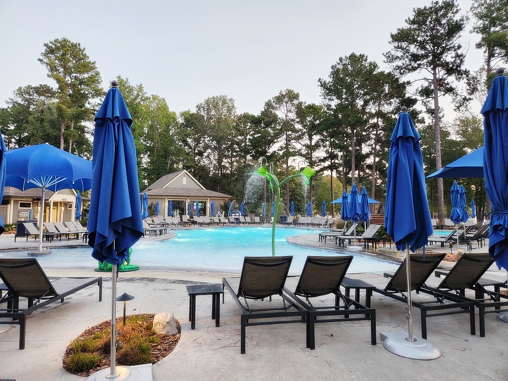 a pool with chairs and umbrellas