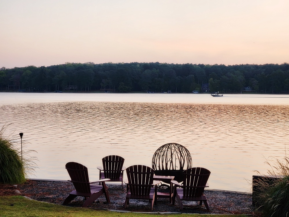 a table and chairs by a lake