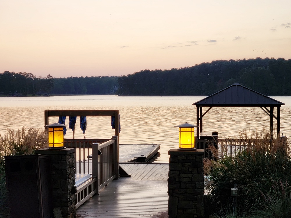 a dock with a building on it next to a body of water