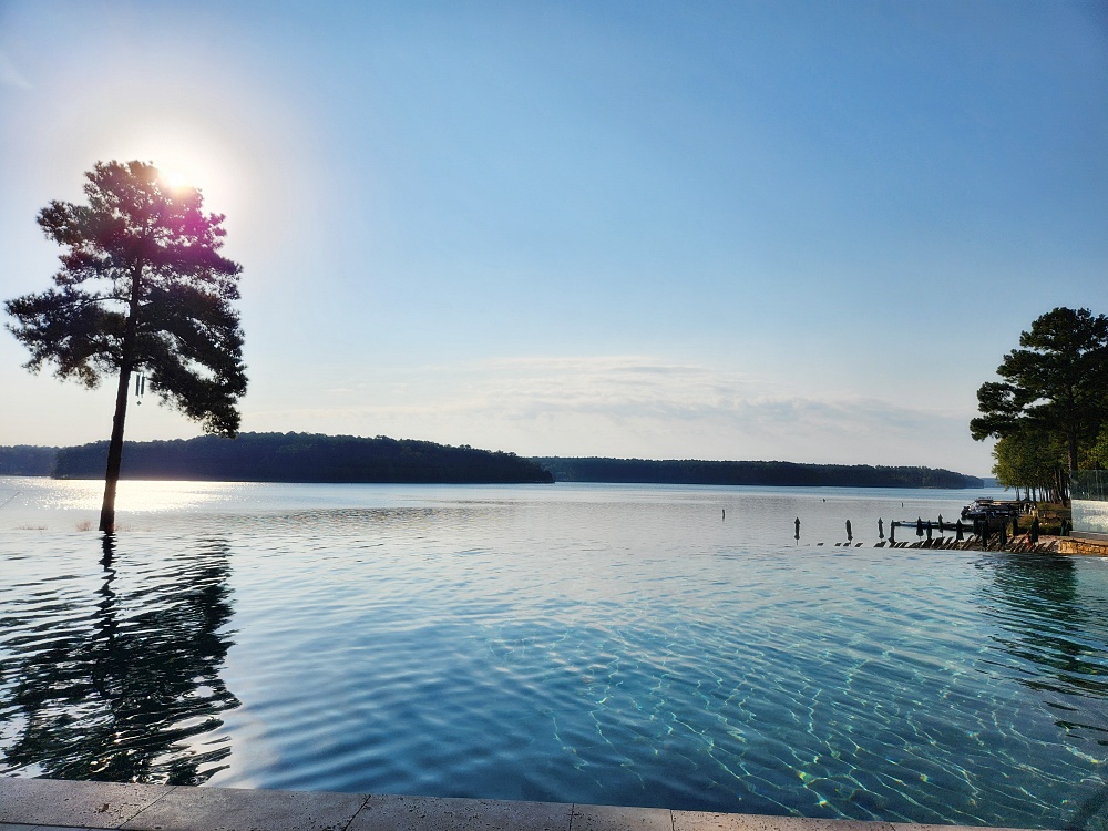 a body of water with trees and a dock in it