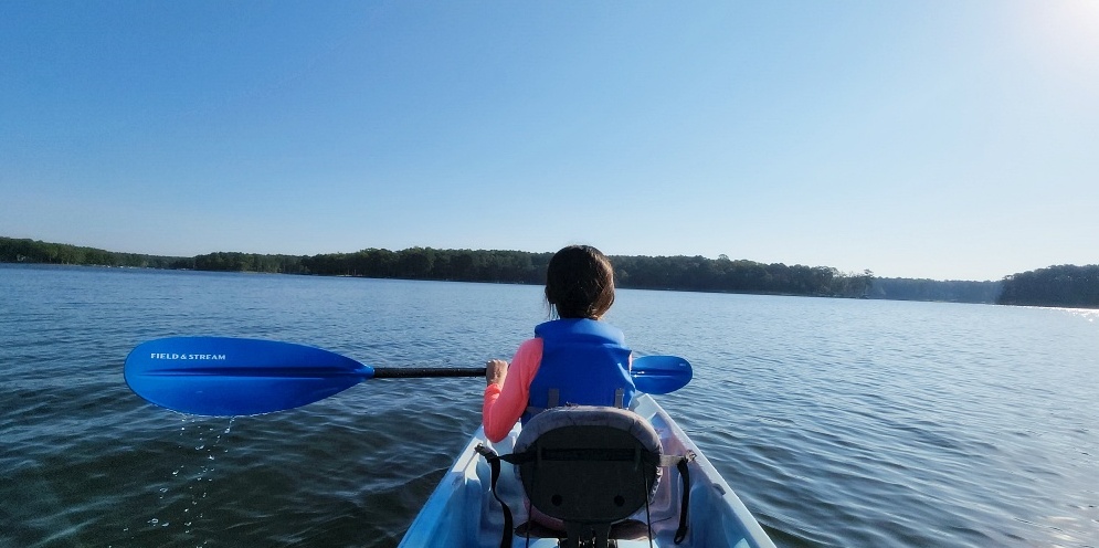 a person in a kayak on a lake