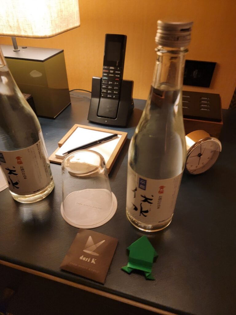 a table with bottles and a cell phone