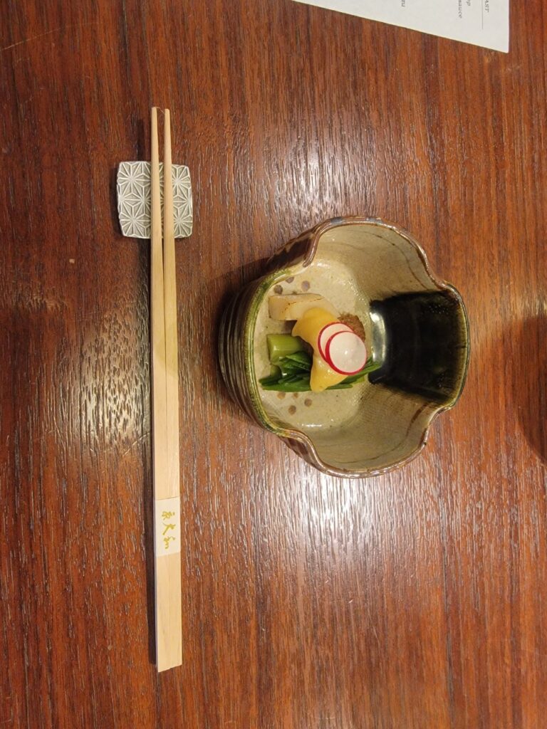 a bottle of alcohol and a cigarette on a table