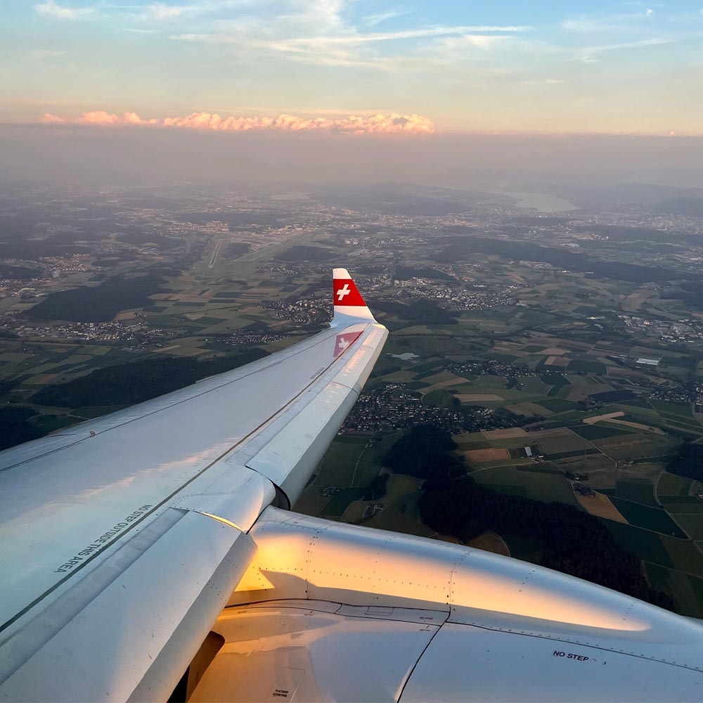 an airplane wing with a city below