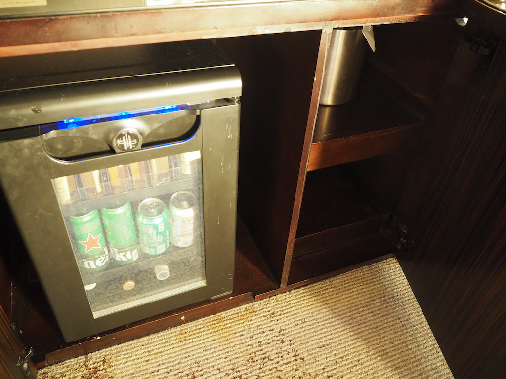 a refrigerator with a few beverages in it