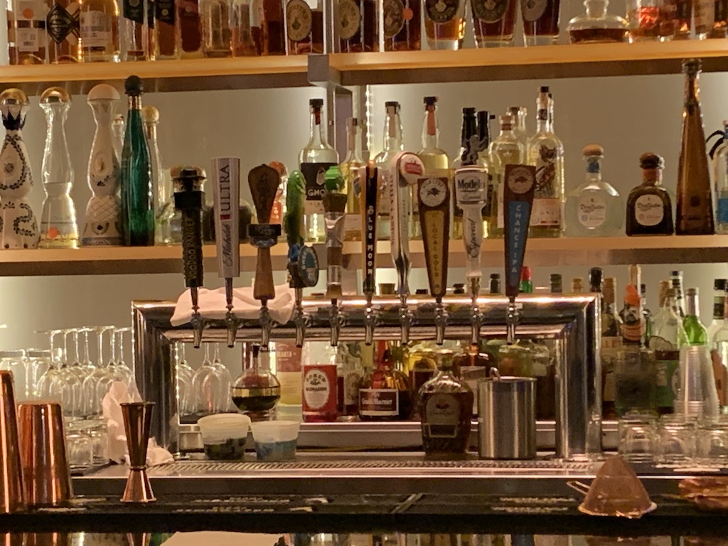 a shelf with bottles of alcohol