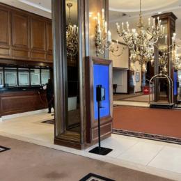 a large lobby with a glass front door and a couple of people