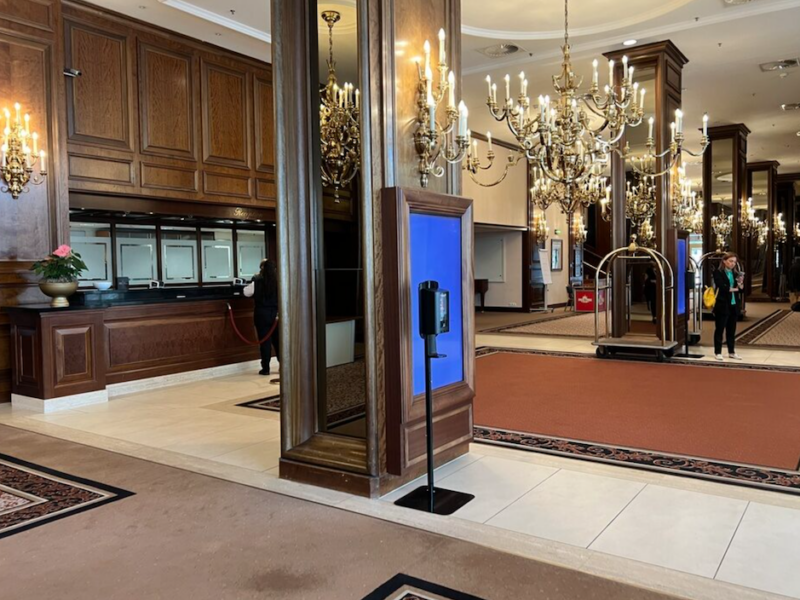 a large lobby with a glass front door and a couple of people