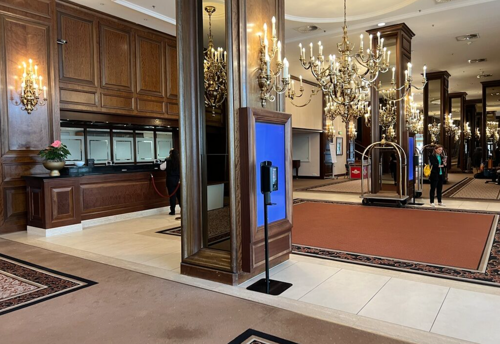 a large lobby with a glass front door and a couple of people