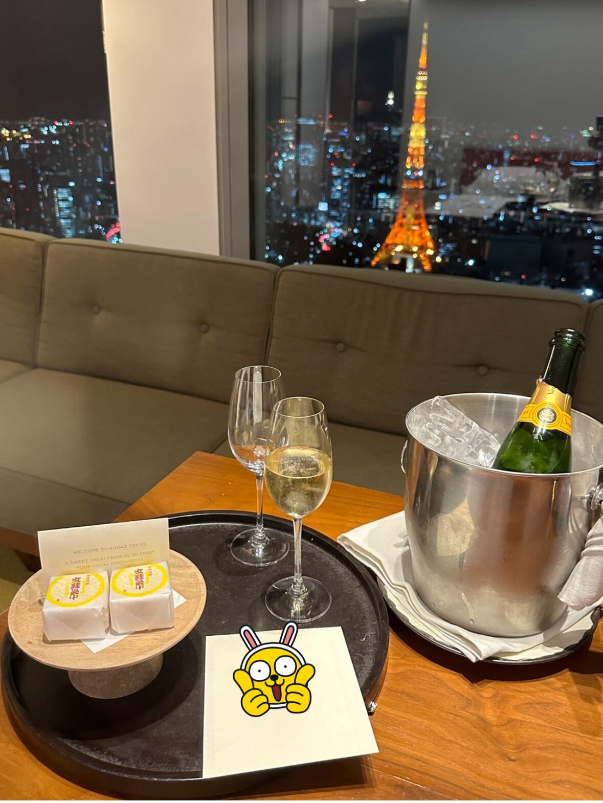 a table with glasses and a bottle of wine on it