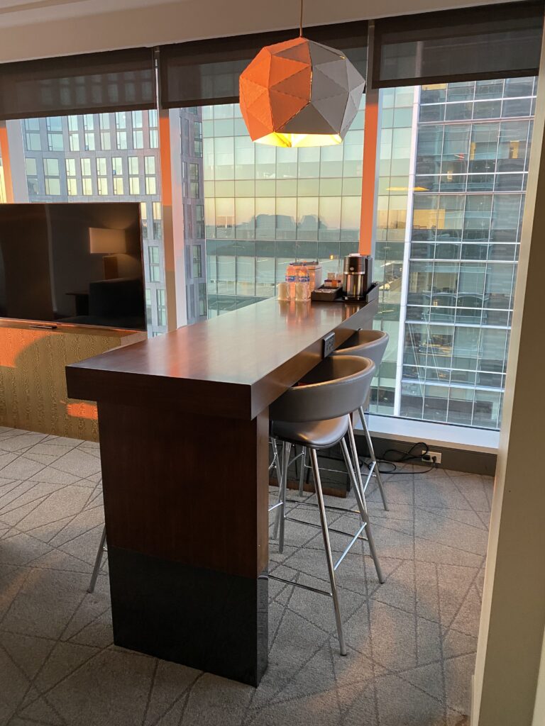 a kitchen with a bar and chairs