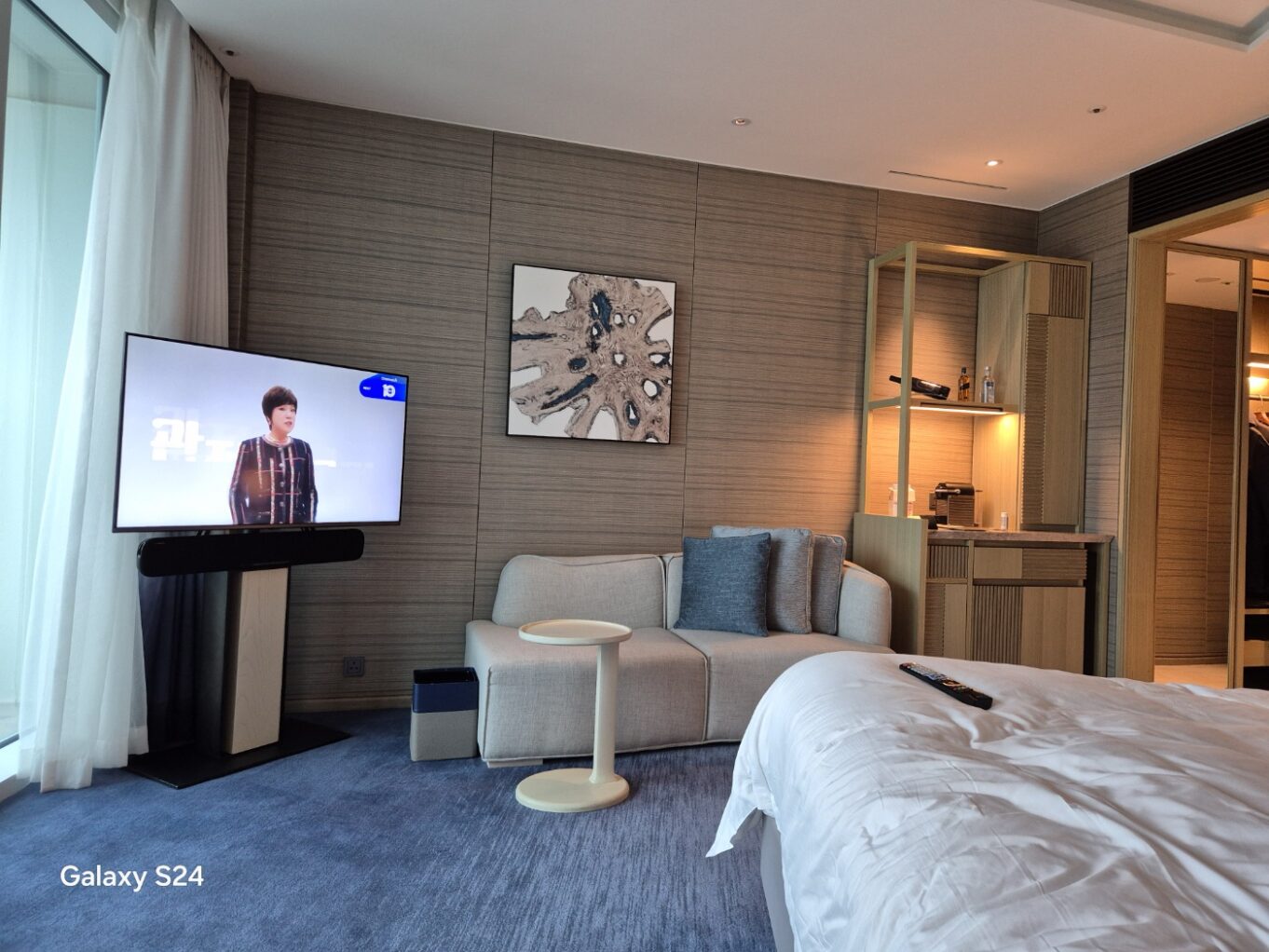 a room with a bed and a television