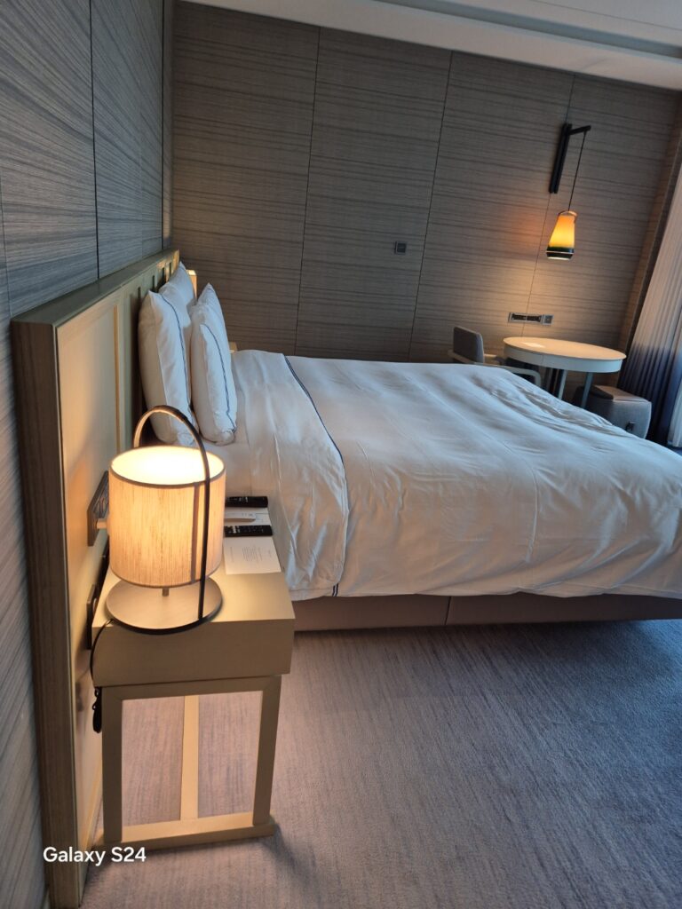 a bed with a lamp on the side