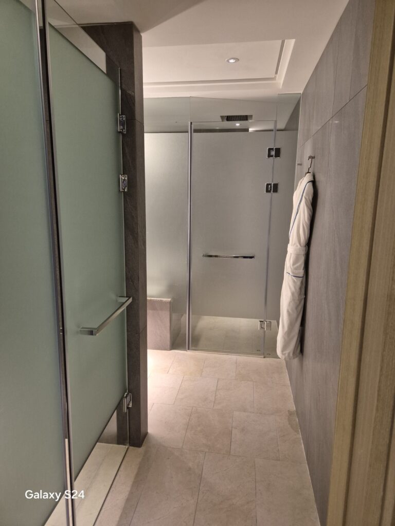 a bathroom with a shower unit and a toilet