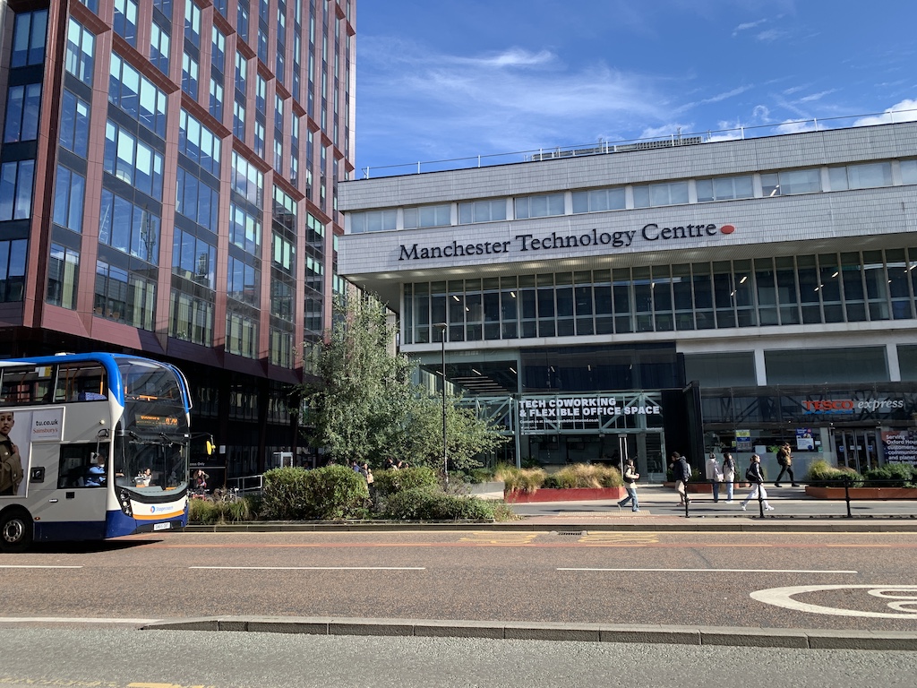 a bus driving by a building