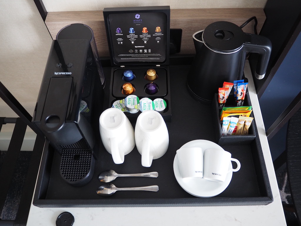 a table with a coffee maker and a coffee cup