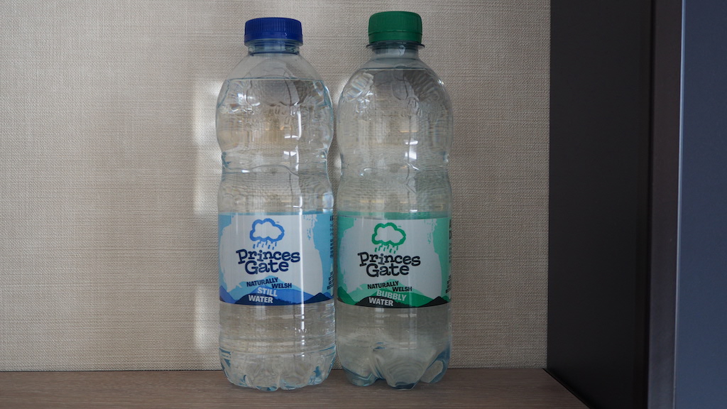 two plastic bottles with blue labels