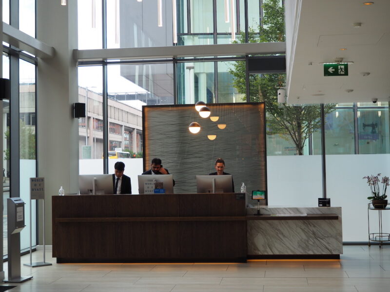 a group of people sitting at a table in front of a building