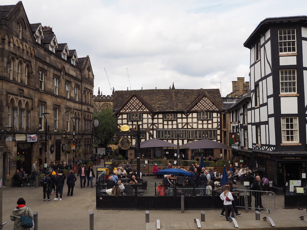 a group of people walking around a town square