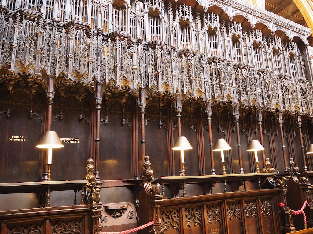 a large ornate room with many chandeliers and a wood railing