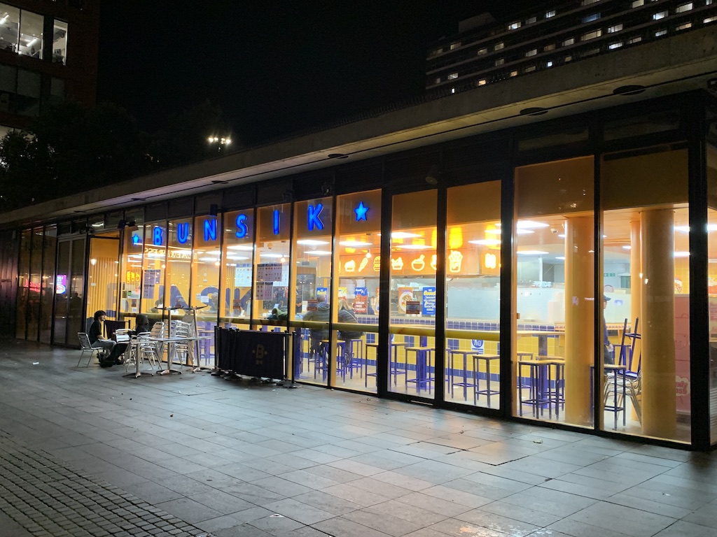 a building with windows and tables outside