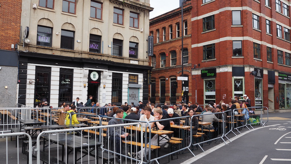 a group of people sitting at a table outside a building