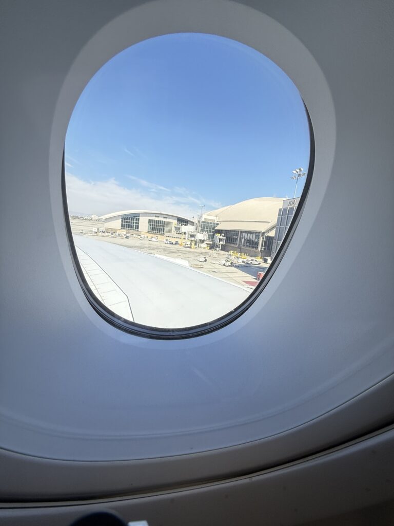 a view of a beach through an airplane window