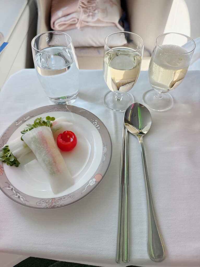 a plate of food and glasses of liquid on a table