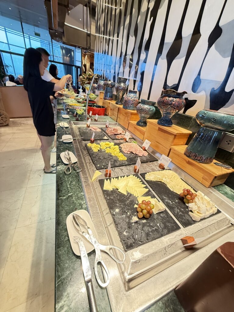 a person standing next to a counter full of food