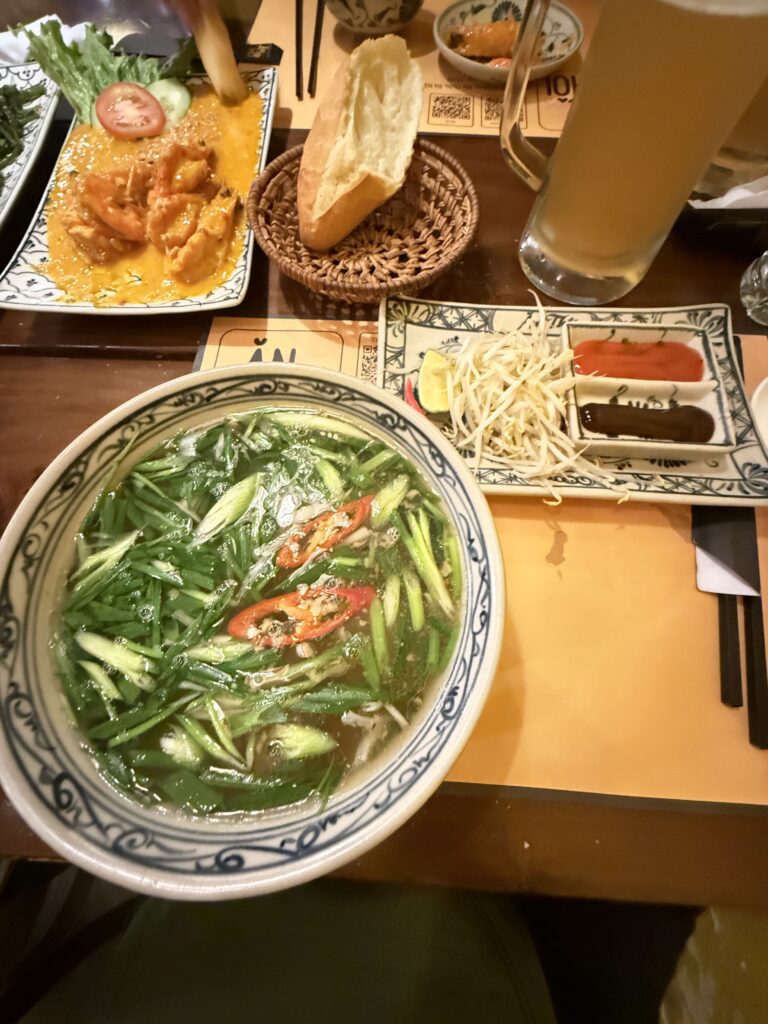 a bowl of soup next to a plate of food