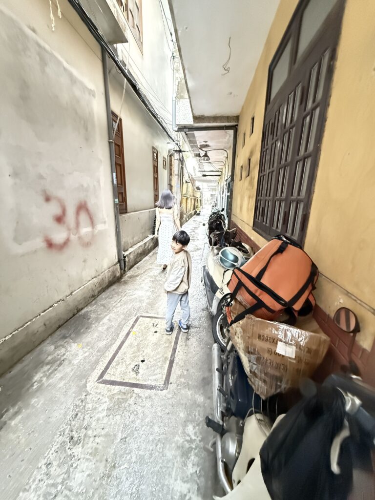 a kid walking down a narrow alley