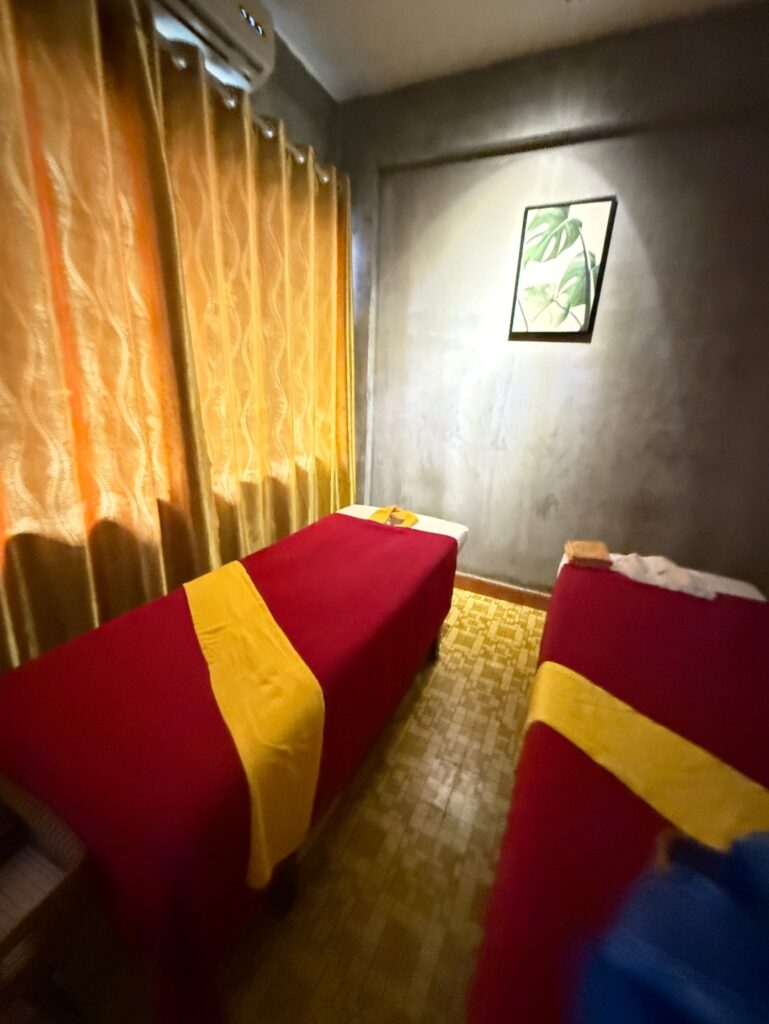 a room with a couch and a table with a yellow curtain