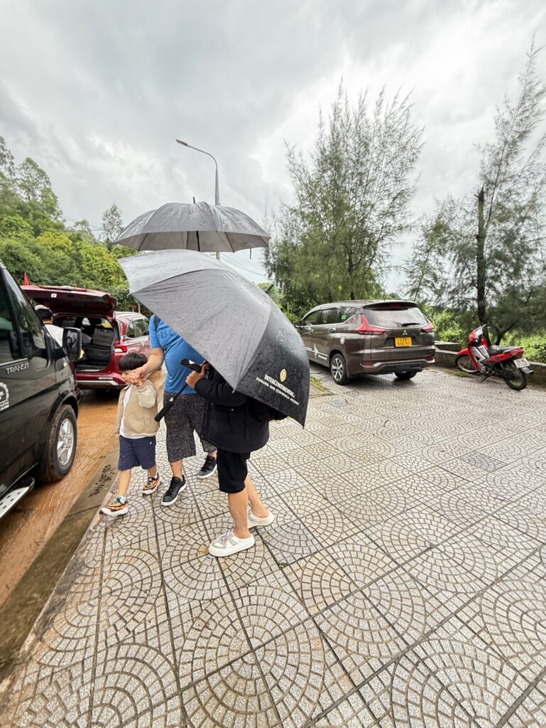 people with umbrellas on a sidewalk