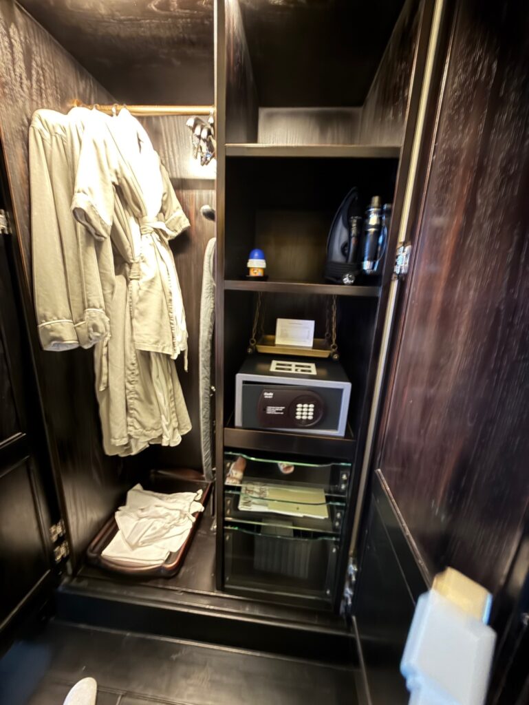 a closet with clothes and a coat rack