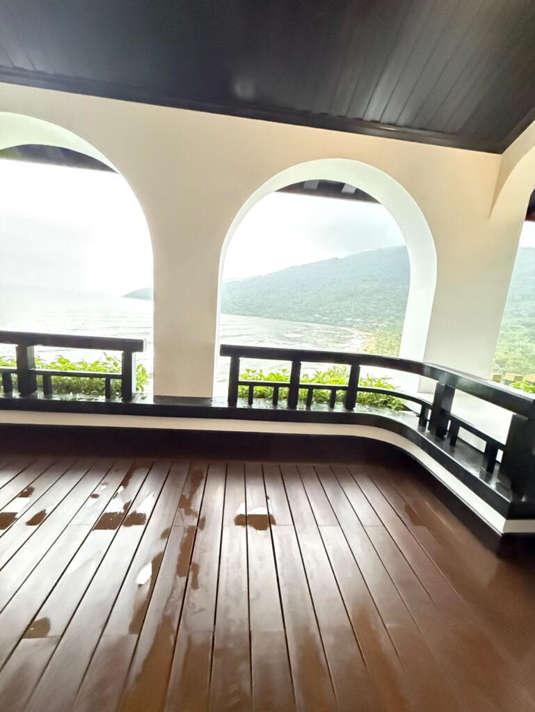 a large arched window with a view of the ocean