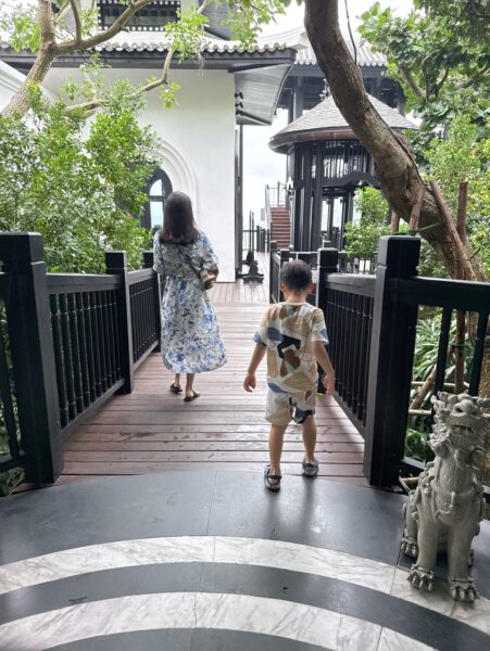 a person and a child walking on a stone path