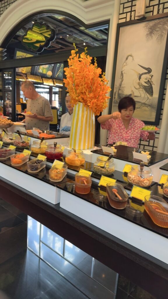 a group of people standing behind a counter with food on it