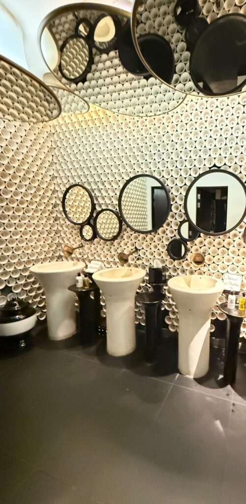 a bathroom with many mirrors