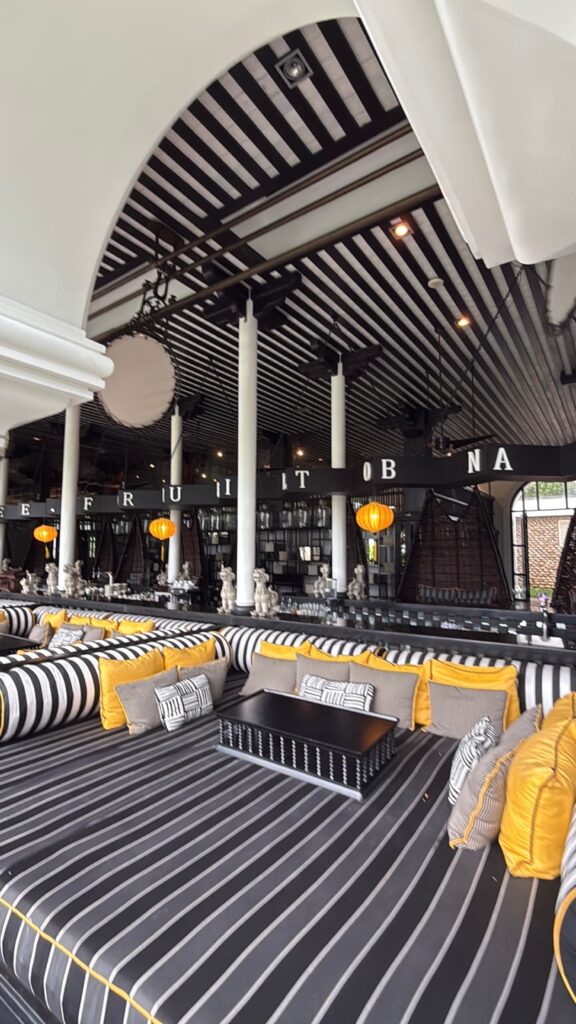 a room with a large white ceiling and many white and black striped chairs