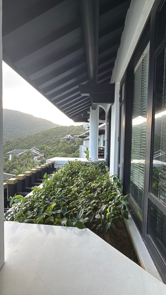 a balcony with a view of a town and hills