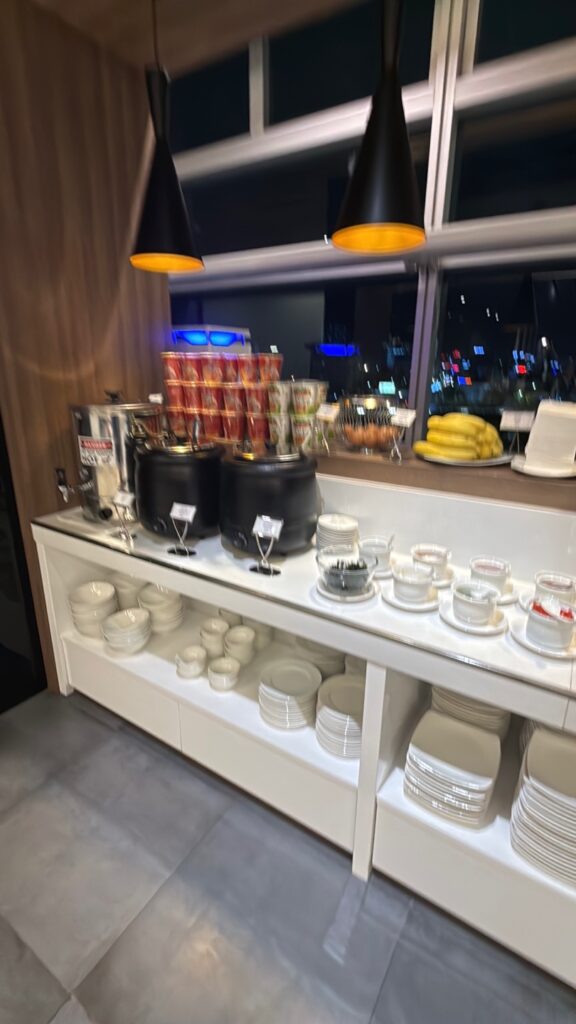 a kitchen with a shelf full of dishes and glasses