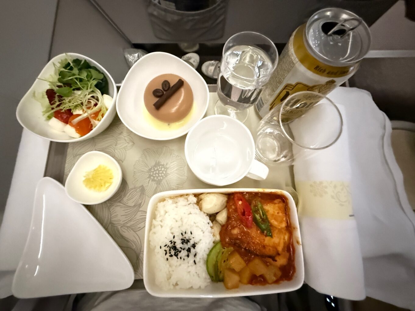 a table with plates of food and glasses of water