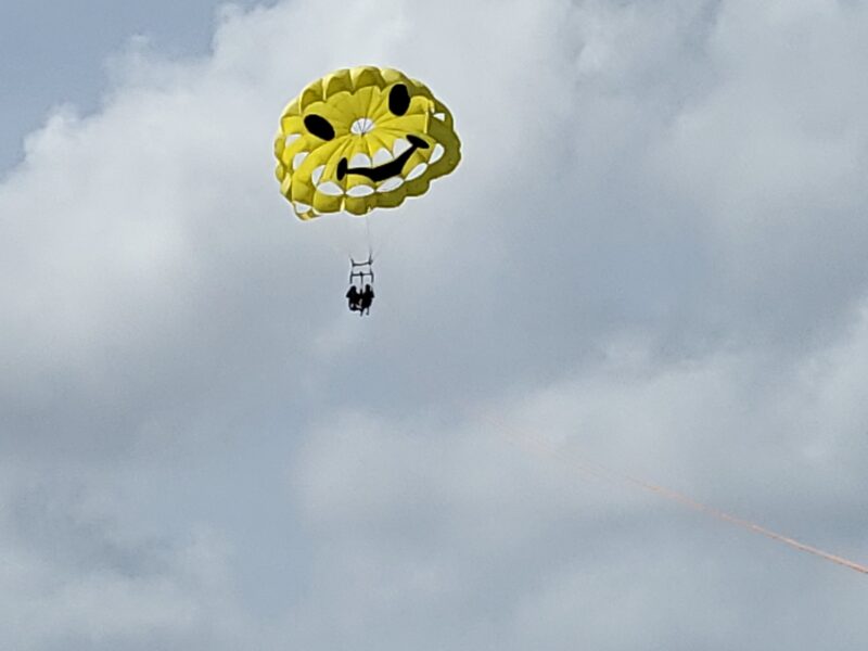 a person in the air with a parachute