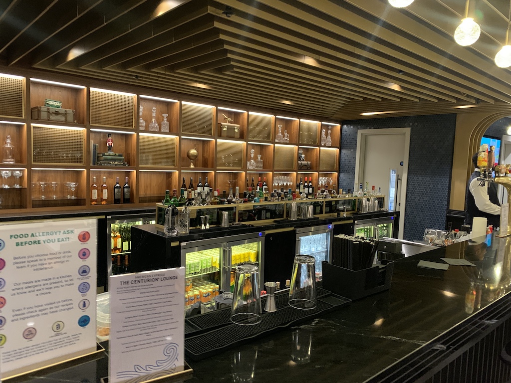 a bar with many glasses on the counter