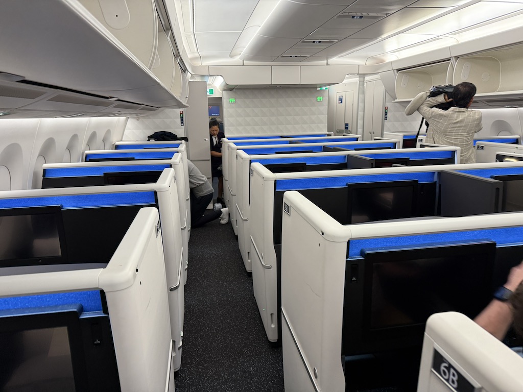 people in a room with blue seats