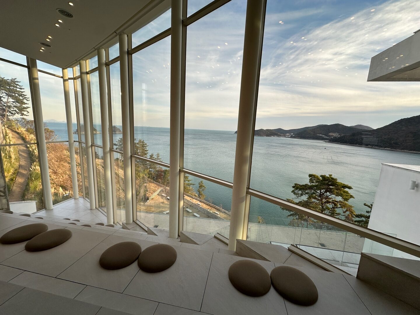 a room with a view of the ocean and mountains